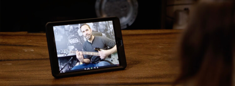 Estudiante realizando su clase virtual de guitarra